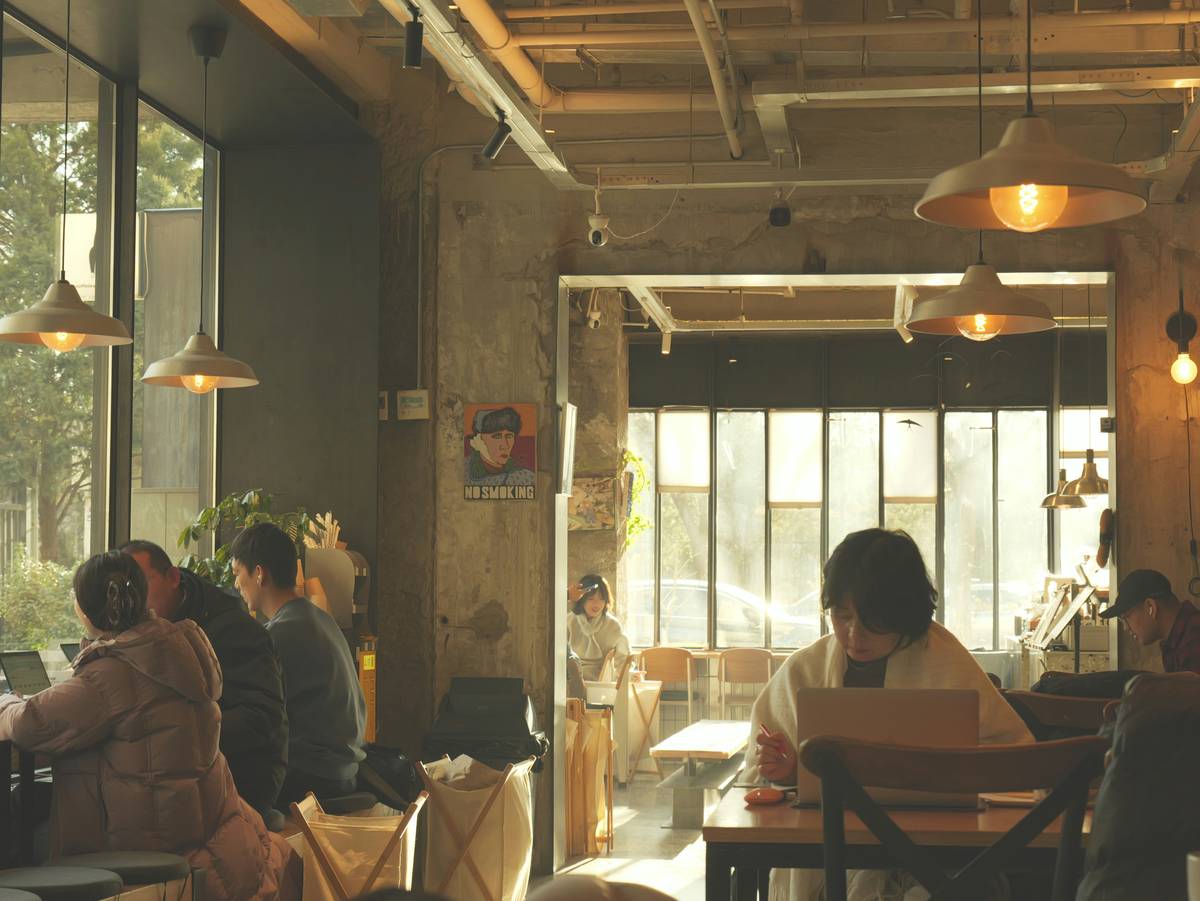 workspot cafe review showing laptop on wooden table with visible power outlet and quiet ambiance